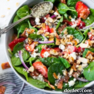 A beautiful strawberry feta spinach salad with poppy seed dressing.