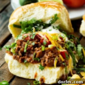 A delicious Taco Sloppy Joe on a bun with toppings.