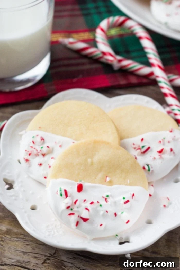 Buttery, melt in your mouth shortbread cookies infused with peppermint then dipped in chocolate and sprinkled with crushed candy canes. These white chocolate peppermint shortbread cookies are perfect for Christmas!