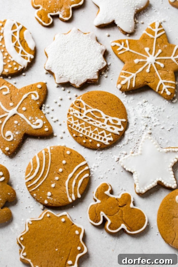 a grey board with the best soft gingerbread cookies recipe decorated with royal icing.