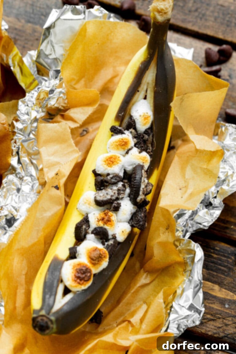 Our Favorite Campfire Banana Boats 11 A rich Oreo Banana Boat, split and filled with crumbled Oreo cookies and gooey melted chocolate, ready for a fork.