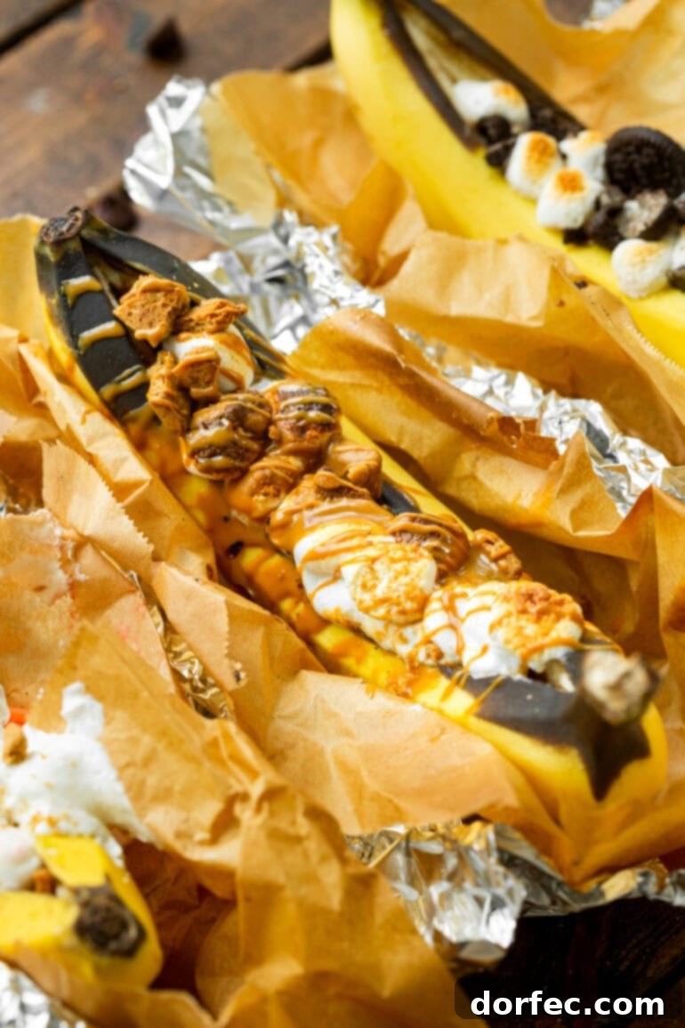 Our Favorite Campfire Banana Boats 13 An inviting spread of various roasted banana boats, each showing off its unique, melted and gooey toppings, promising a delicious outdoor dessert.