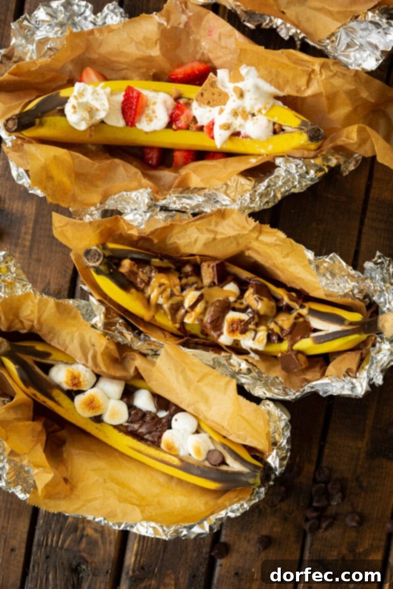 Our Favorite Campfire Banana Boats 8 A captivating overhead shot of several perfectly cooked campfire banana boats, each adorned with a unique and tempting array of melted toppings, inviting you to dive in.