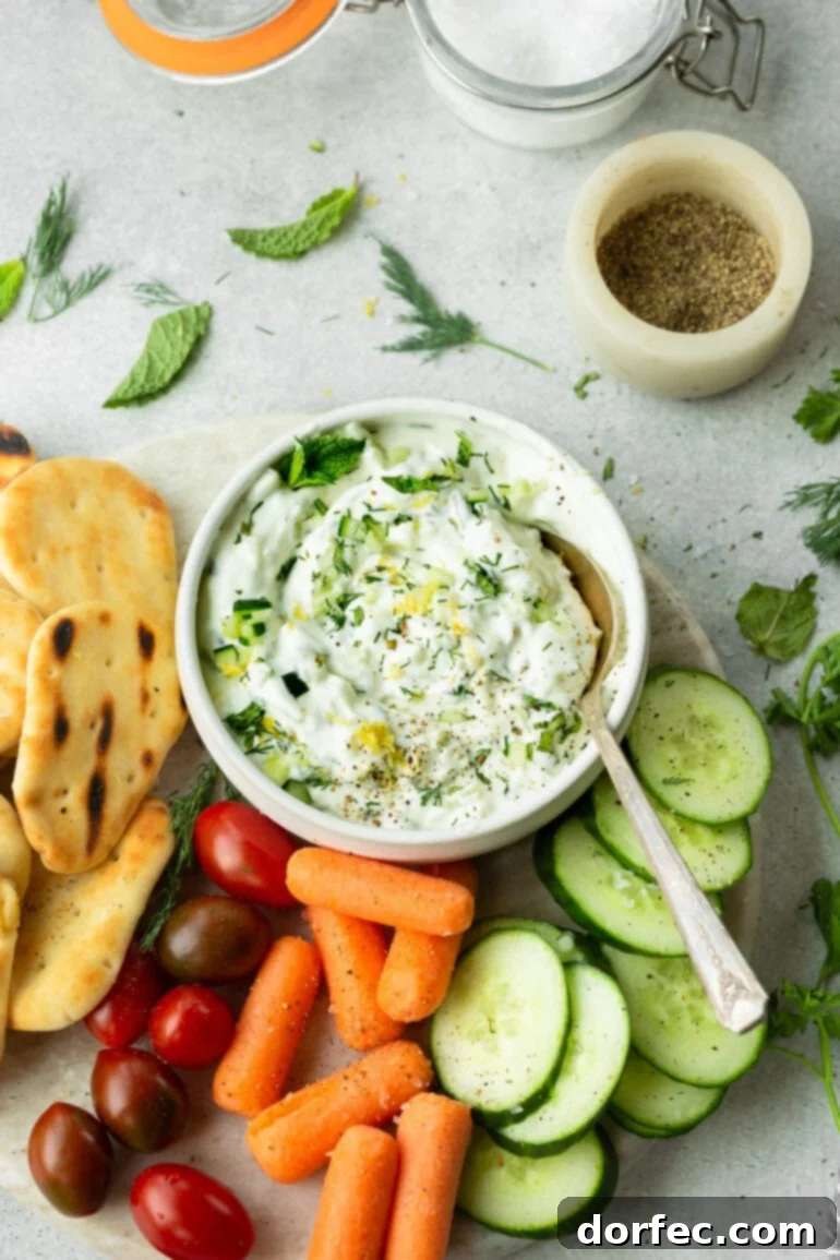 Freshly made tzatziki sauce garnished with dill and pepper, ready to serve as a versatile dip.