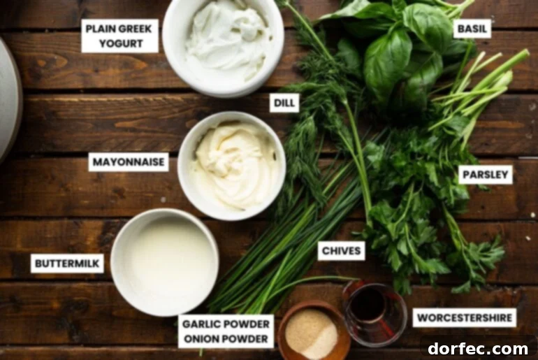 A beautifully arranged photo of fresh basil dressing ingredients: vibrant basil leaves, lemon zest, lemon juice, tahini, and salt and pepper.