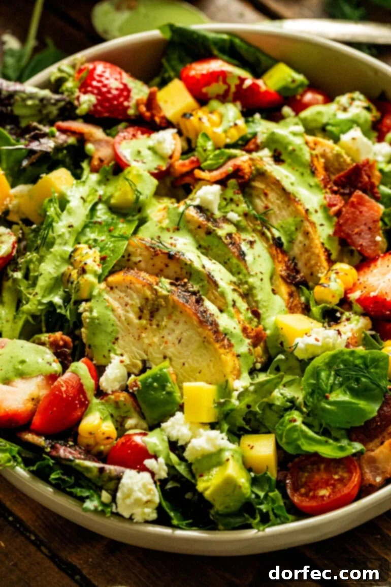 A visually appealing photo of homemade basil dressing artfully drizzled over a summer salad, garnished with succulent sliced chicken breast.