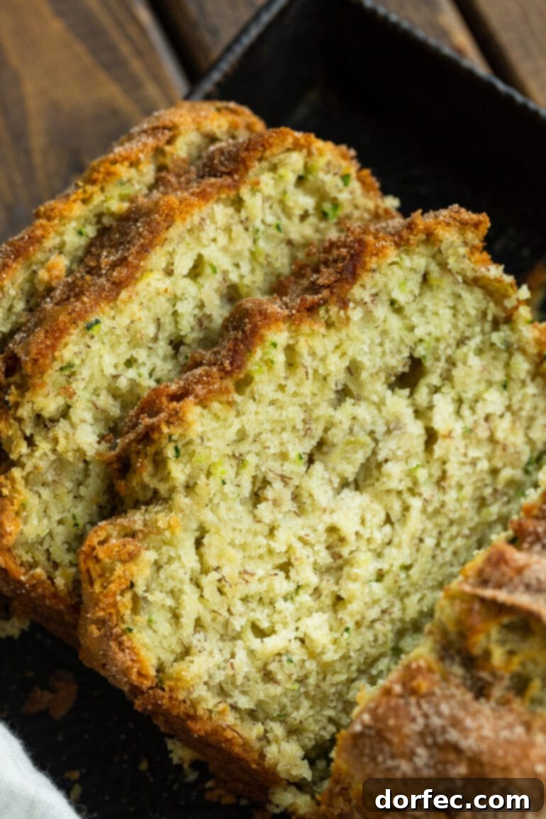 A photo of three enticing slices of banana zucchini bread, perfectly baked and leaning on each other, ready to be enjoyed.