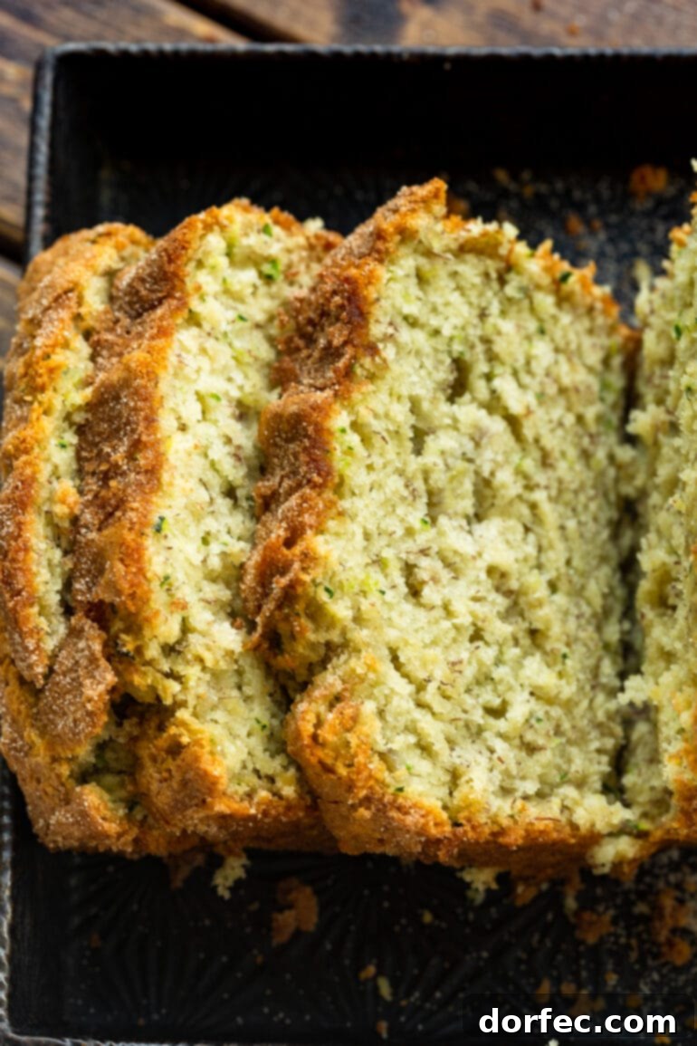 A top-down view photo showing several slices of banana zucchini bread artfully arranged, falling onto each other, highlighting their inviting texture.
