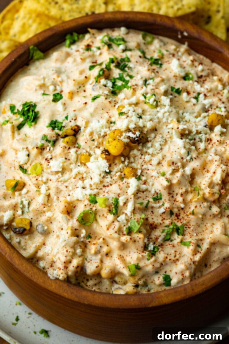 Zesty Mexican Street Corn Dip 5 a photo of a wooden bowl full of cold mexican street corn dip.