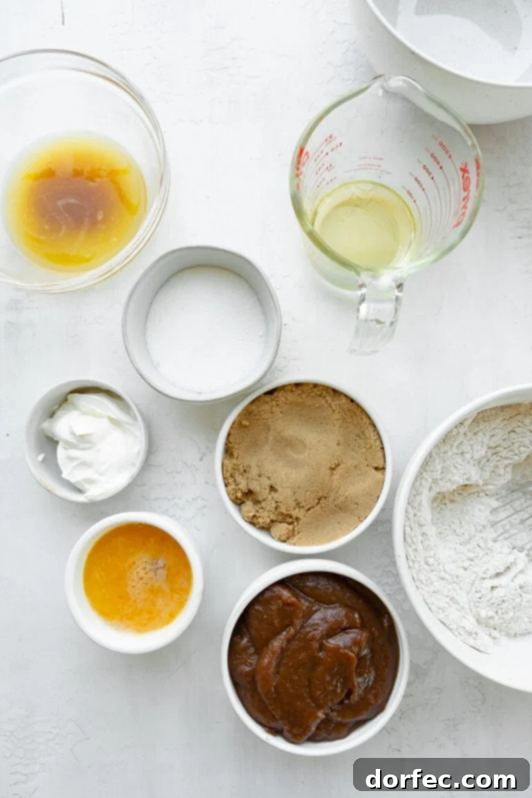 A vibrant collection of apple bread ingredients, neatly arranged in small bowls, showcasing the freshness and quality of each component.