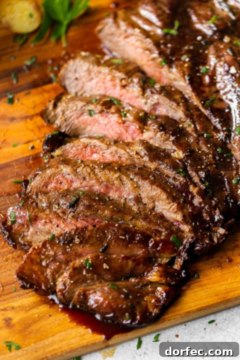 Succulent, thinly sliced flank steak, perfectly marinated and grilled, showcasing a beautiful char.