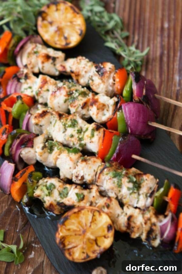 Weekly Meal Plan: September 25 - October 1 3 Grilled Greek Chicken Souvlaki skewers, beautifully browned and tender, presented on a plate with fresh lemon wedges and a sprinkle of herbs, ready for a delicious meal. ohsweetbasil.com