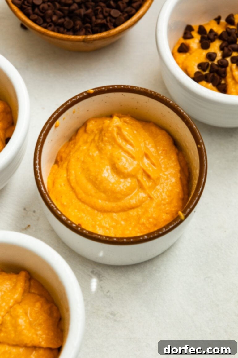 Blender with pumpkin mug cake batter, ready to be poured into a mug for baking.