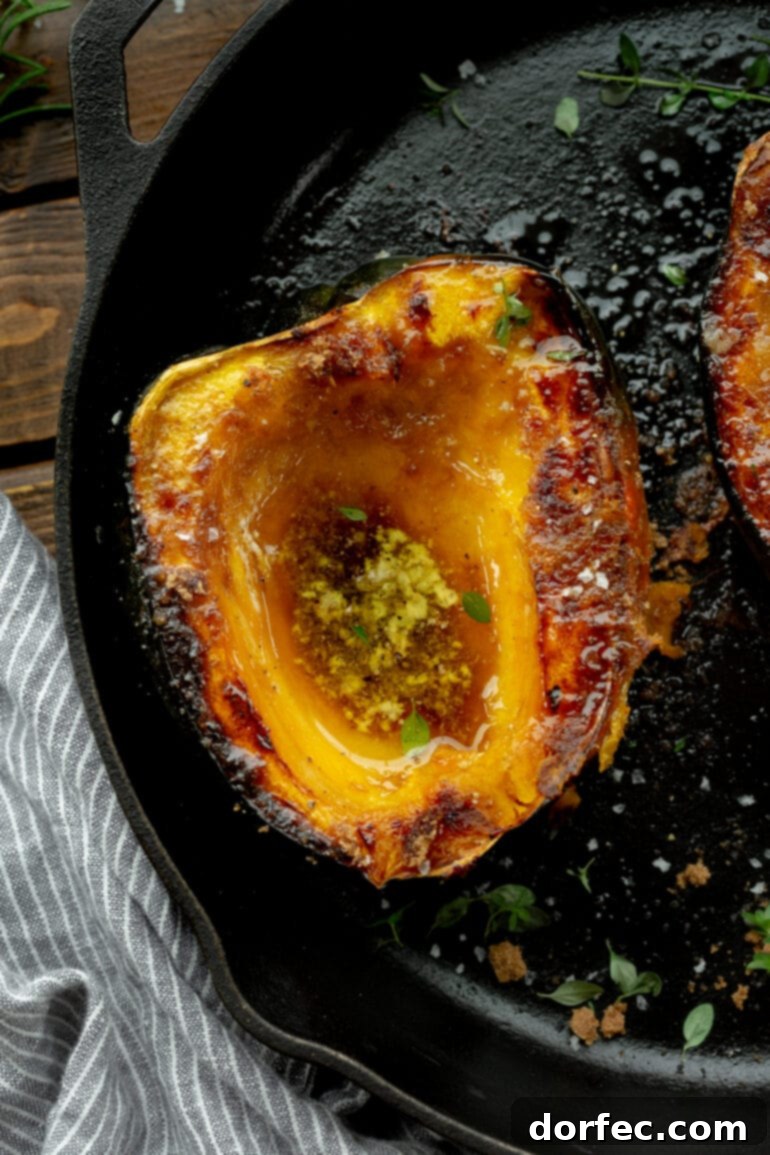 A stunning photo of a halved acorn squash sitting on a cast iron skillet, roasted until golden and caramelized, ready to be enjoyed.
