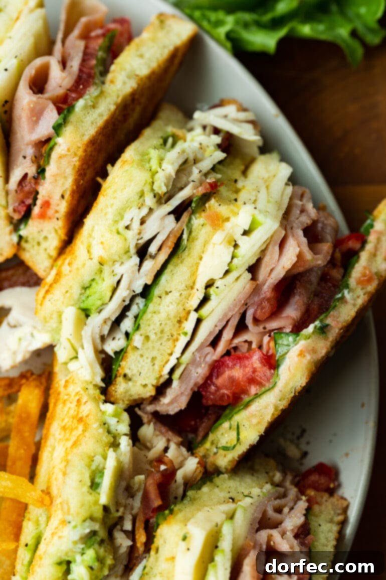A perfectly layered triple decker club sandwich with golden brown toast