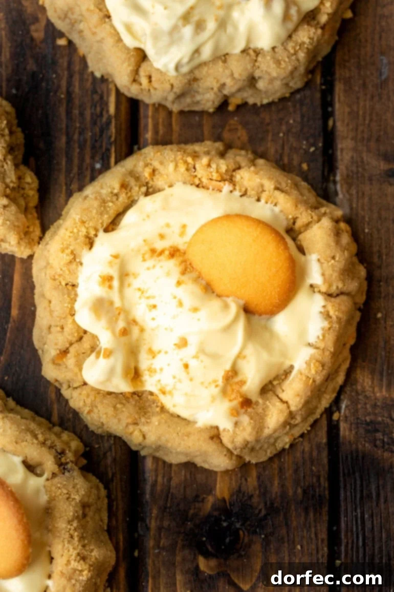 Giant Banana Cream Pie Cookies 2 a photo taken over the top of a banana cream pie cookie topped with a Nilla wafer and graham cracker crumbs