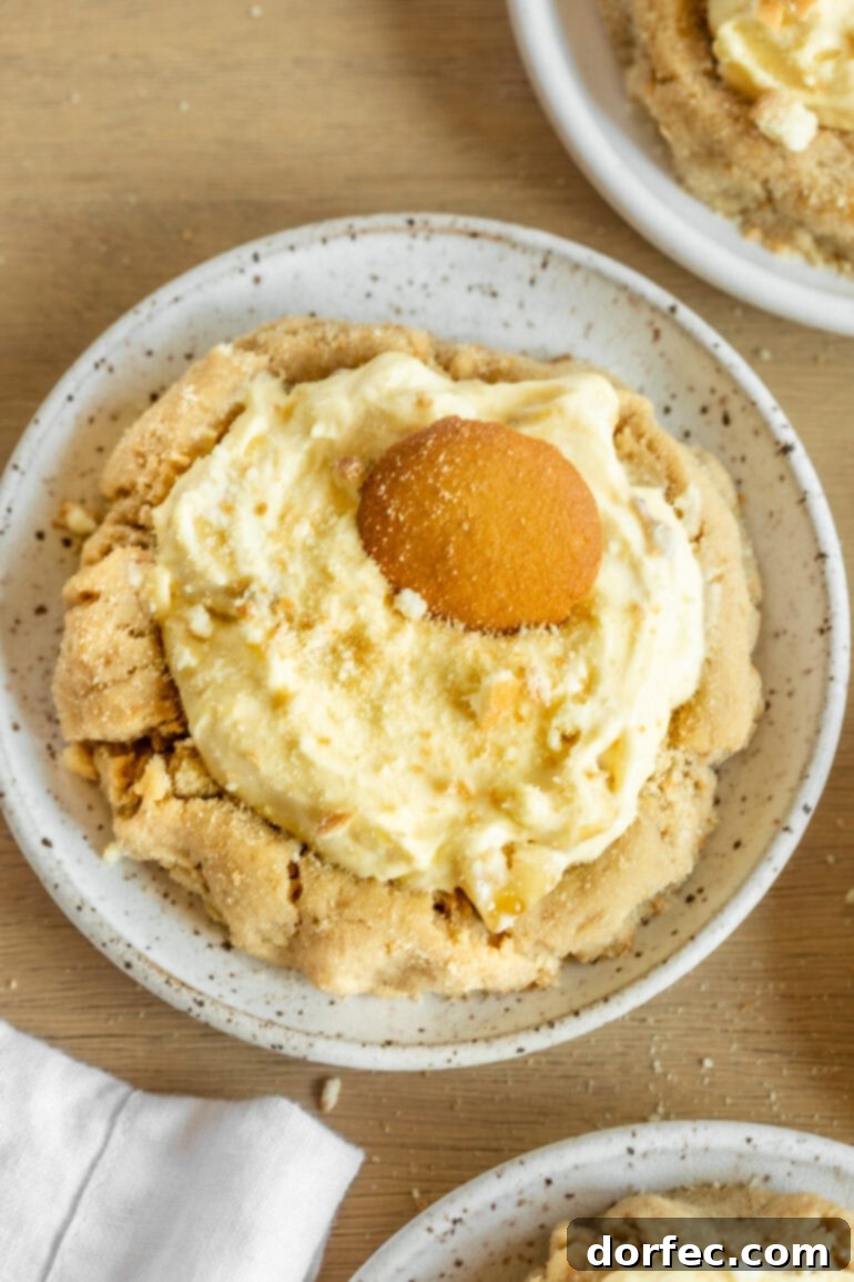 Giant Banana Cream Pie Cookies 7 a photo taken over the top of a banana cream pie cookie topped with a nilla wafer.