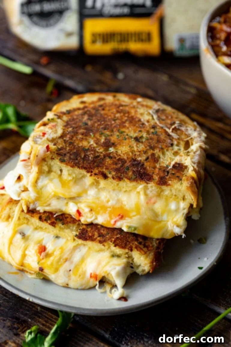 A photo of a Mexican style grilled cheese sandwich, golden and gooey, cut in half and stacked to reveal the melted cheese inside, a perfect midweek treat.