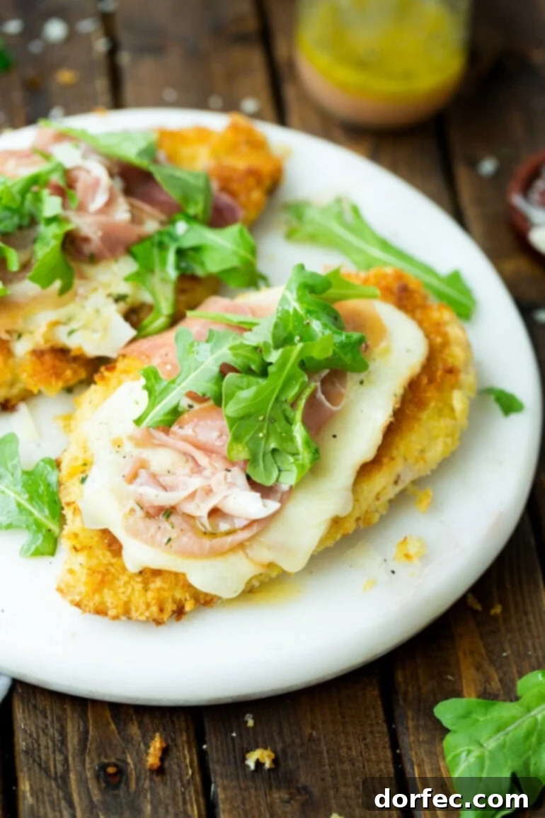 Meals for the Week: November 27 to December 3 4 A photo of a golden breaded chicken breast topped with melted Taleggio cheese, prosciutto, and arugula, all drizzled with a red wine vinaigrette.