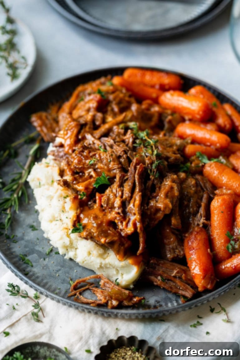 Meals for the Week: November 27 to December 3 9 A photo of a plate full of mashed potatoes topped with juicy tender pot roast with a side of cooked carrots.