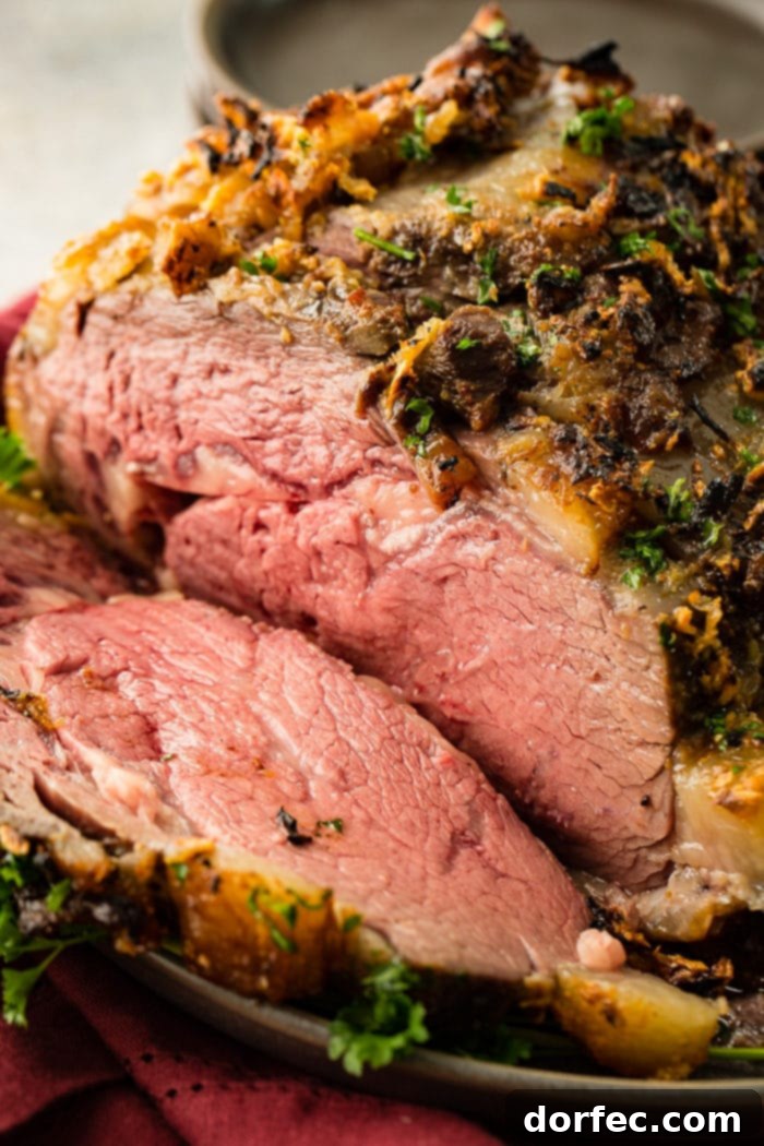 A beautifully roasted garlic prime rib on a platter, ready for carving, the perfect Christmas dinner centerpiece.