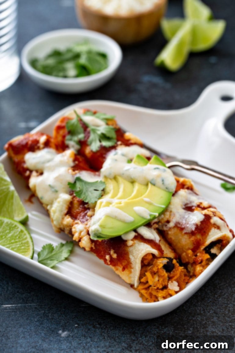 Weekly Meal Plan January 1-7 8 A dinner plate with two enchiladas on it, garnished with red enchilada sauce, queso fresco cheese, avocado, cilantro, and a sweet corn crema drizzle.