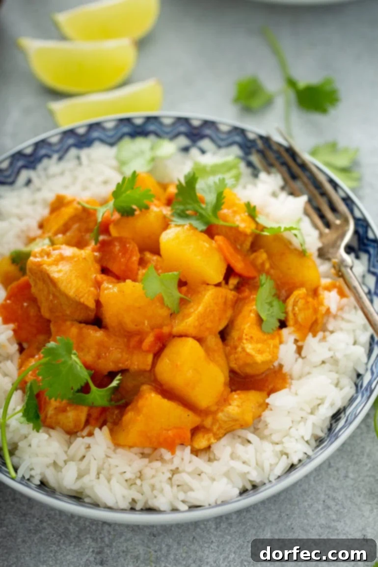Your Weekly Meal Plan January 8-14 7 A hearty bowl of white rice topped with flavorful Instant Pot Chicken Curry, featuring succulent chicken chunks, carrots, and potatoes in a rich curry sauce, garnished with fresh parsley.