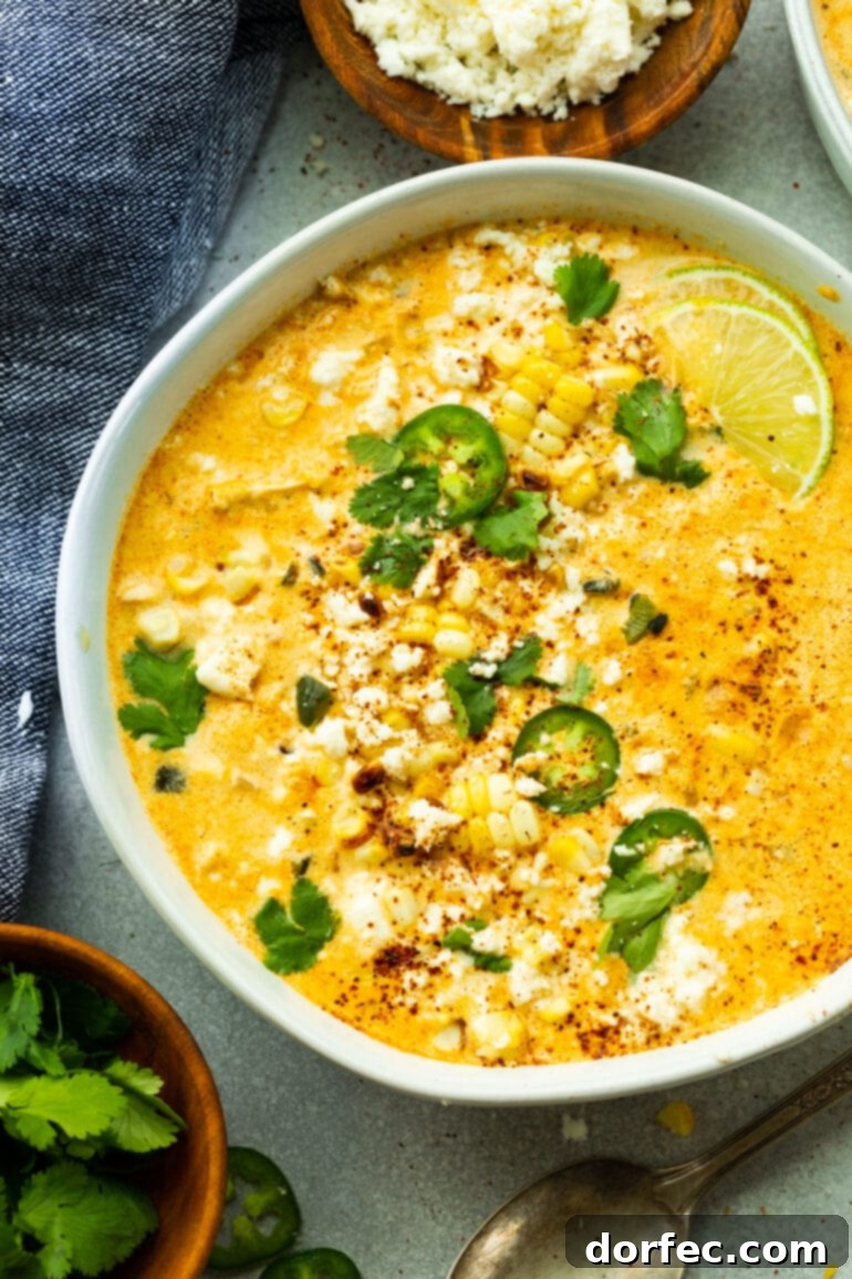 Elote Corn Soup 3 An inviting overhead shot of a large white bowl brimming with Mexican Street Corn Soup, beautifully topped with vibrant chopped cilantro and thinly sliced jalapeños, showcasing its rich texture and enticing garnishes.