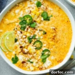 Elote Corn Soup 9 A large bowl of creamy Mexican Street Corn Soup, garnished with vibrant sliced jalapeños, fresh chopped cilantro, and bright lime wedges. This quick and easy soup brings the classic Elote flavors to your dinner table.