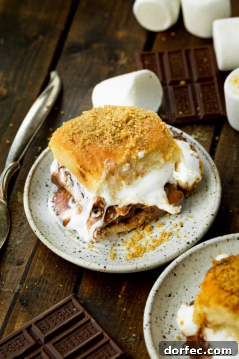 S'mores Sliders 7 A single, gooey and delicious s'mores slider sitting on a small dessert plate, ready to be enjoyed.
