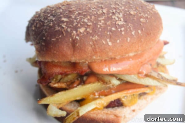 Weekly Meal Plan: April 22-28 7 Sweet Basil's Over The Top Tillamook Bacon Cheeseburger, showcasing a thick, juicy patty, crispy bacon, melted Tillamook cheese, and fresh toppings on a toasted bun.