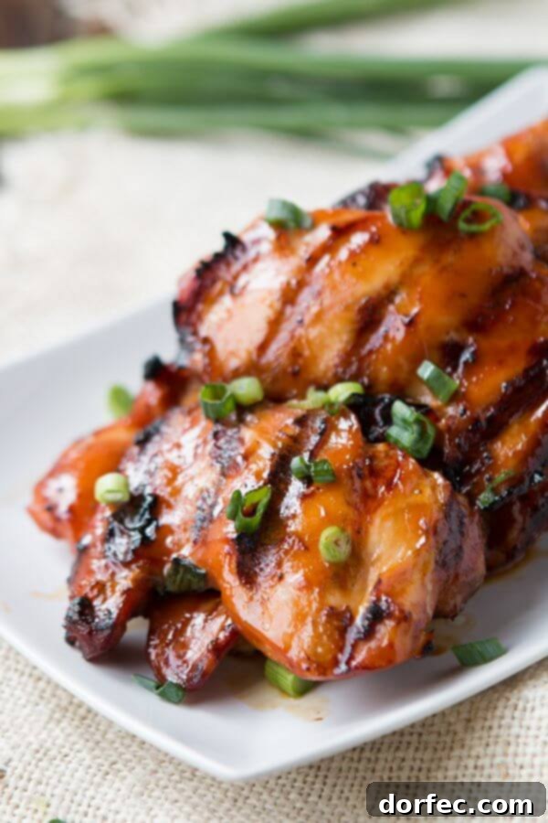 A close-up of beautifully grilled Hawaiian chicken, showcasing caramelized edges and a glistening, flavorful glaze, promising an incredibly delicious meal.