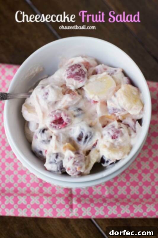 This cheesecake fruit salad is awesome for a side at a potluck or BBQ or even as a dessert! Plus it's so easy it's foolproof! A refreshing bowl of cheesecake fruit salad, highlighting its appeal as an effortless side for summer gatherings or a delightful dessert for any occasion.