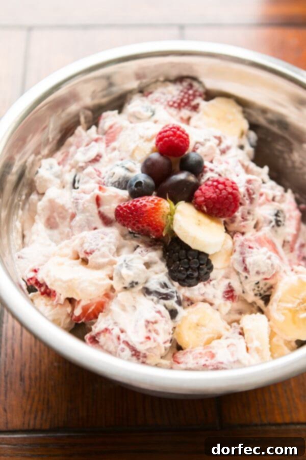 This cheesecake fruit salad is awesome for a side at a potluck or BBQ or even as a dessert! Plus it's so easy it's foolproof! A vibrant and appealing cheesecake fruit salad, guaranteed to be a hit as a simple side or an unforgettable dessert at any event.