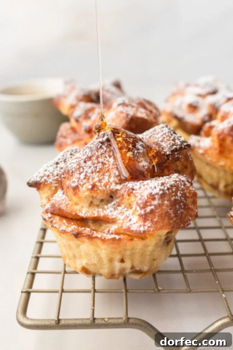 A collection of golden-baked air fryer French toast muffins displayed on a wire cooling rack, highlighting their perfectly browned and inviting appearance.