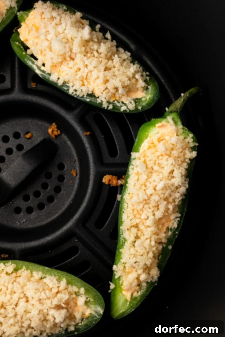 A photo gallery showcasing the assembled jalapeño poppers ready for the air fryer, promising a perfect party snack.