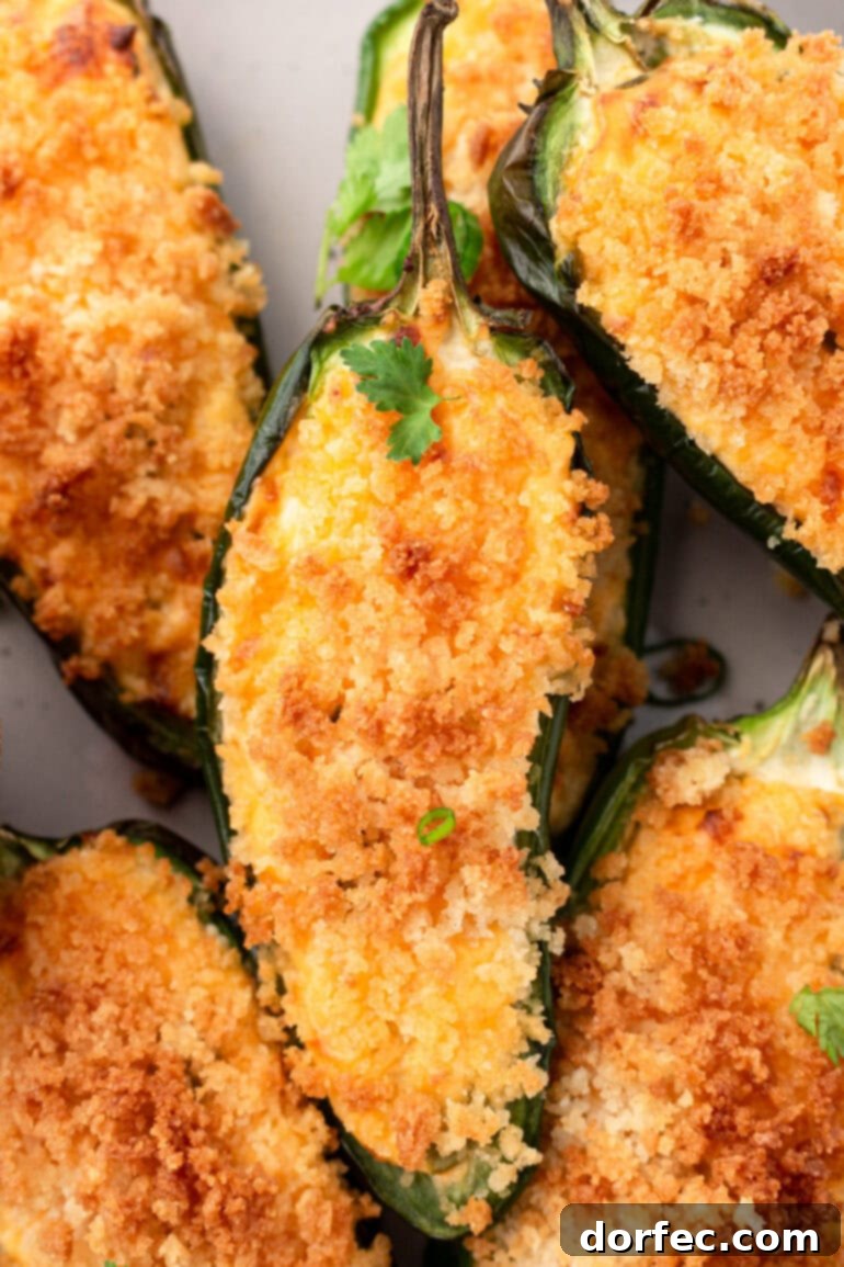 A close-up, overhead photo of perfectly golden, crispy air fryer jalapeño poppers, ready to be served as a snack.