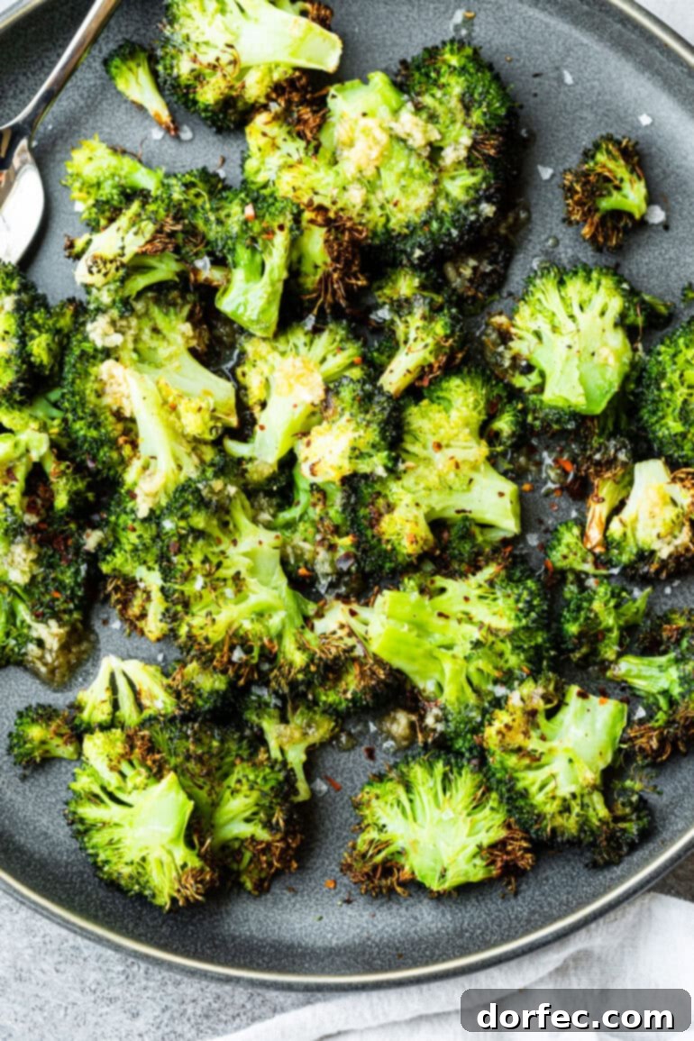A close-up shot of a plate brimming with perfectly smashed, air-fried crispy broccoli florets.