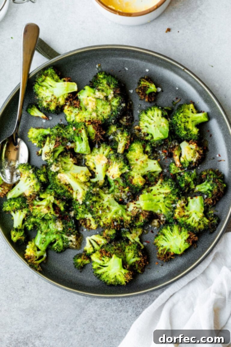 A beautifully plated dish of golden-brown, smashed air-fried broccoli florets.