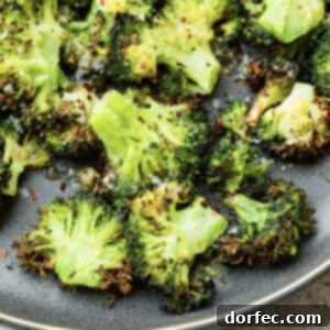 A vibrant photo of crispy smashed broccoli florets piled on a serving plate, ready to be enjoyed.