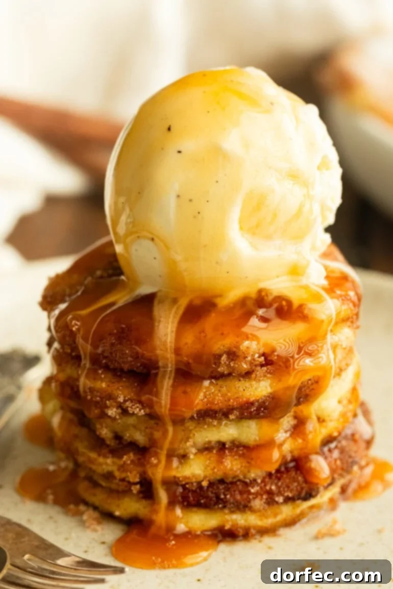 A stack of golden air-fried apple rings, topped with a scoop of melting vanilla ice cream and drizzled with warm caramel sauce, creating an irresistible fall dessert.