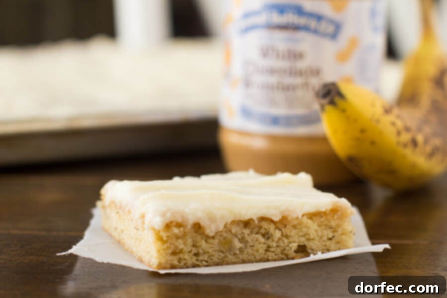 Moist White Chocolate Peanut Butter Banana Cake Slice Close-up of a slice of moist White Chocolate Peanut Butter Banana Cake with rich cream cheese frosting