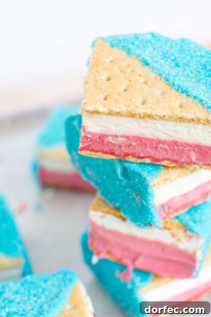Refreshing Red Velvet, White and Blue Ice Cream Sandwiches, featuring layers of no-churn red velvet, white chocolate chip, and cheesecake ice cream with a festive blue shell.