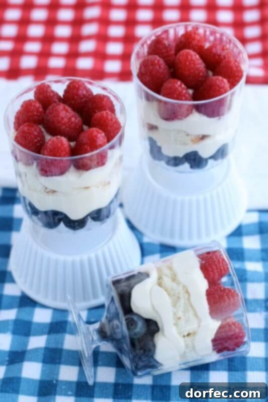 Elegant Patriotic Trifles, layered with cake, fruit, and cream, creating a beautiful red, white, and blue dessert for festive occasions.
