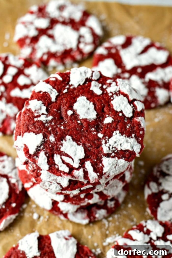 Red Velvet Crinkles, with their signature powdered sugar coating creating white crinkles on a chewy red velvet cookie base.