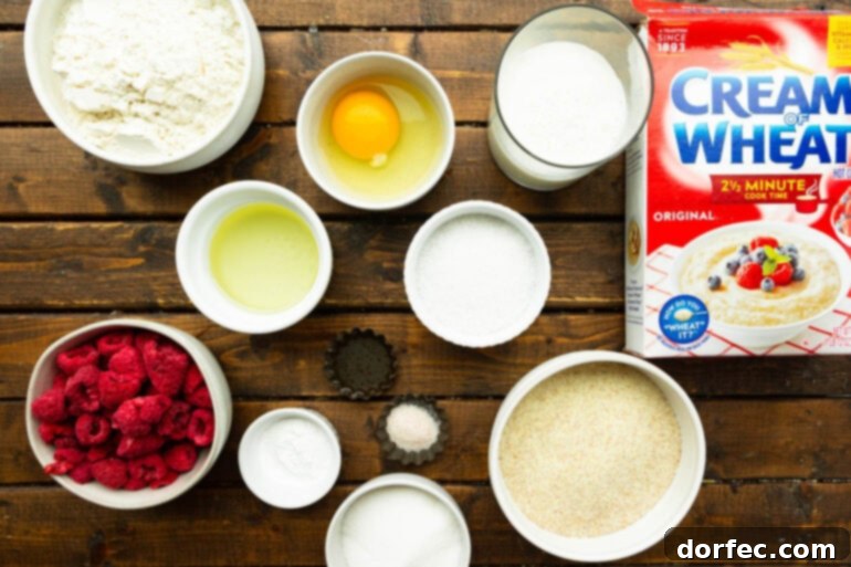 An overhead shot showcasing all the neatly arranged ingredients for Cream of Wheat Raspberry Muffins, presented in individual small bowls.