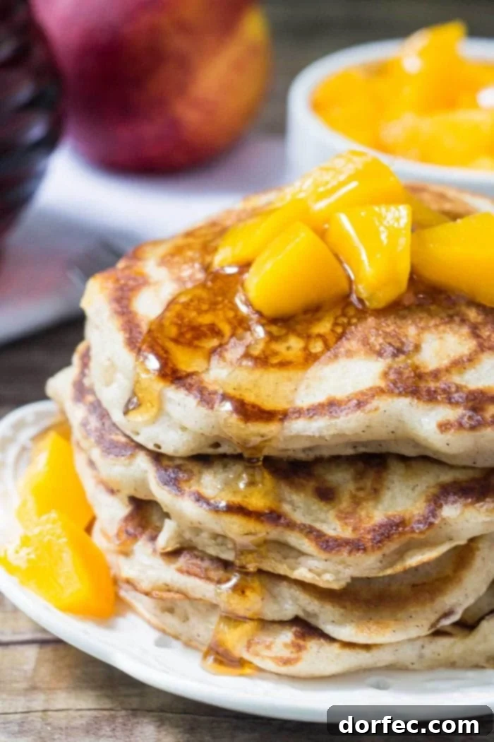 A stunning close-up of light and fluffy brown sugar peach pancakes, showcasing their golden edges and delicious texture, ready to be enjoyed as the perfect breakfast.
