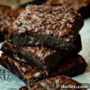 Decadent Box Mix Brownies 9 A freshly baked homemade brownie with a crinkled top, captured in a square frame, perfect for a recipe card image.