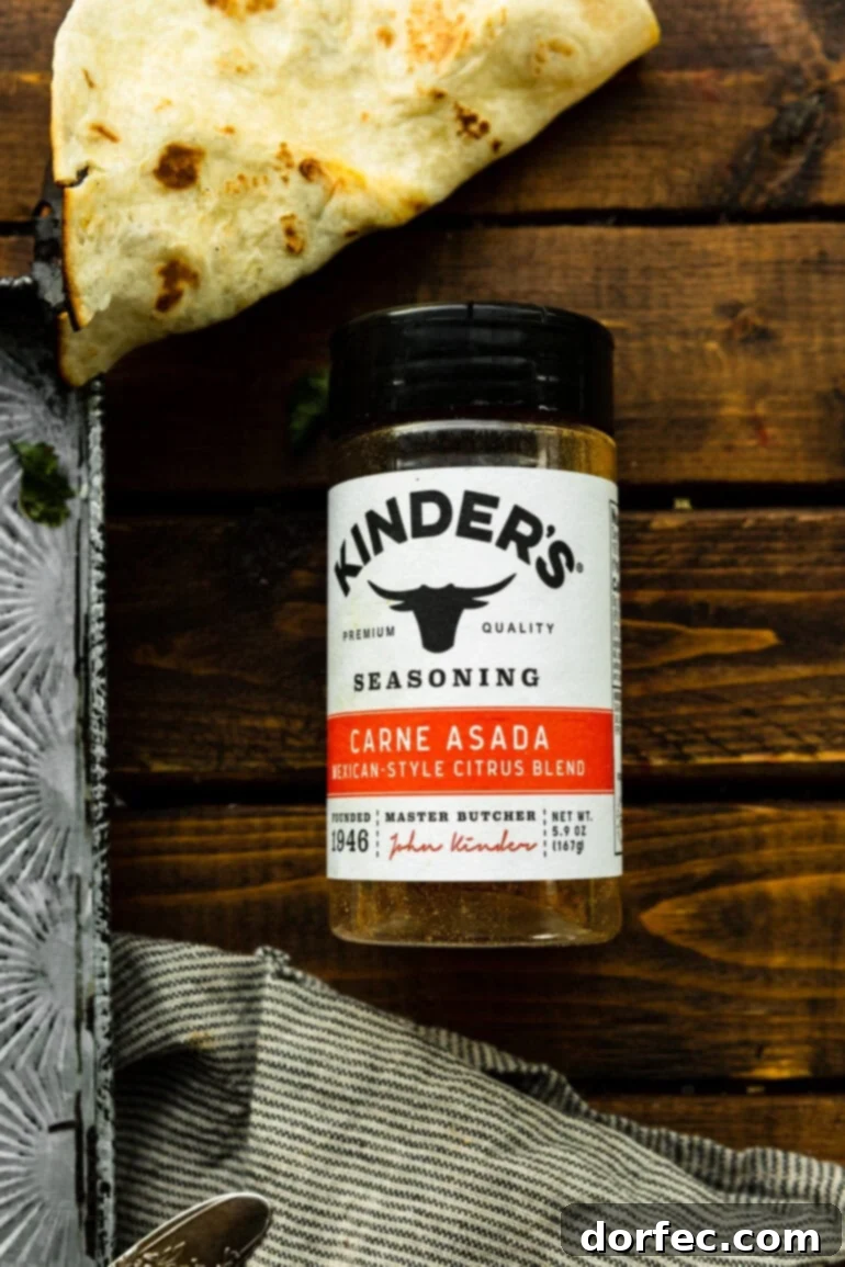 A clear photo of a bottle of Kinder's Carne Asada Rub, showcasing its vibrant label and promising a burst of Mexican flavors.