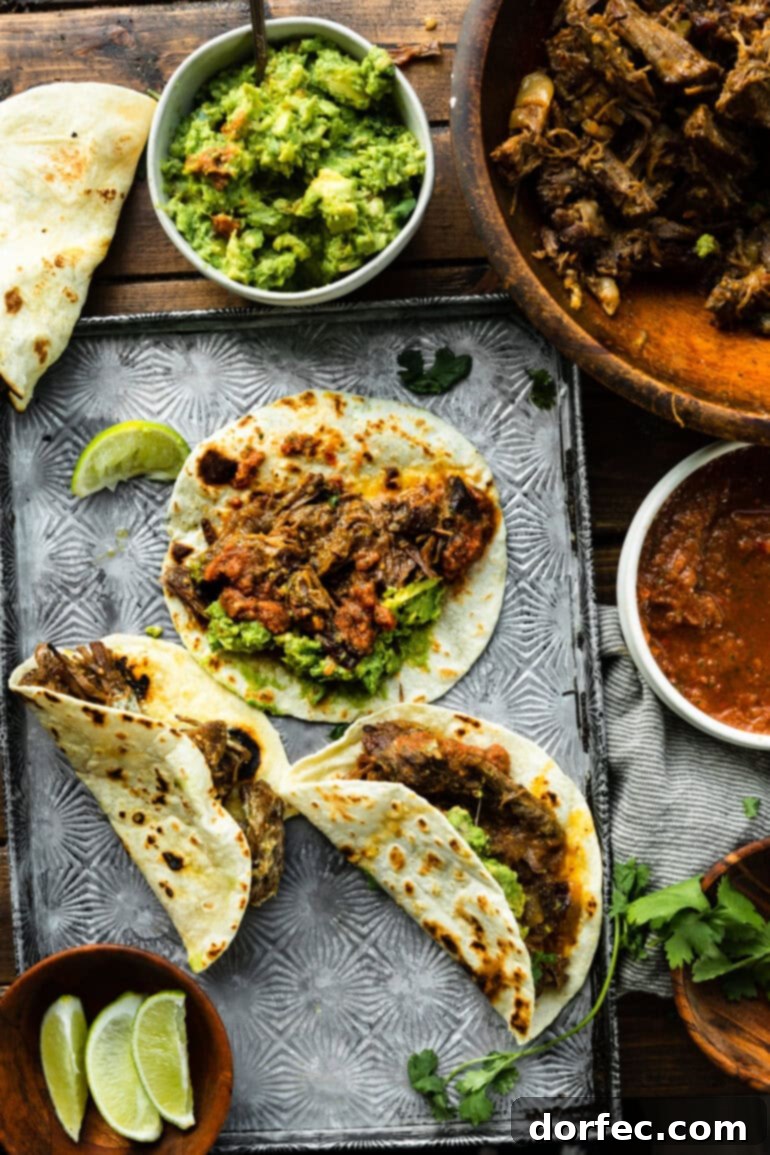 A delectable spread of shredded beef tacos on warm flour tortillas, artfully arranged with a side bowl of vibrant guacamole, inviting guests to customize their perfect taco.